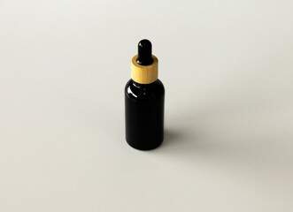 Minimal Black Cosmetic Serum Container on Neutral Surface