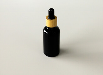 Minimal Black Cosmetic Serum Container on Neutral Surface