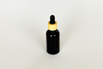 Minimal Black Cosmetic Serum Container on Neutral Surface