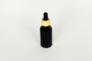 Minimal Black Cosmetic Serum Container on Neutral Surface