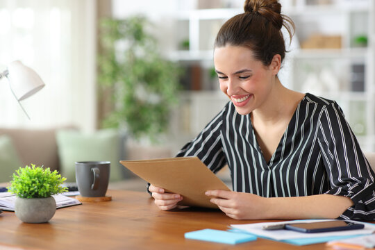 Happy self employed reading paper documents working