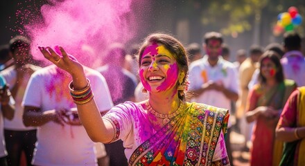 A woman covered in colorful powder celebrates Holi with a joyful crowd