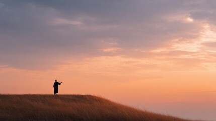 A silhouette of Jesus preaching on the hill