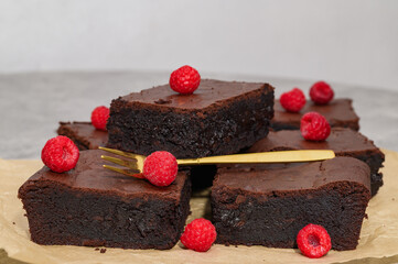 Chocolate cake, close-up of dark brownie pieces, chocolate cube
