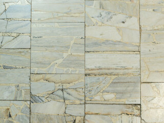 Marble wall tiles with decorative cracks close-up