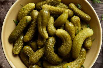 Pickled cucumbers in bowl. Close up view