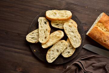 Slices of ciabatta bread on cutting board