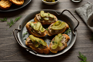 Open sandwiches with liver pate on wooden background