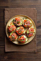 Smoked salmon toasts with cream cheese, fresh cucumber and greens