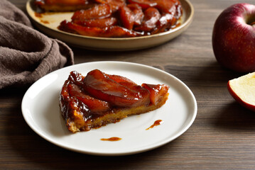 Slice of apple tarte Tatin with sweet caramelized red apples and sugar caramel