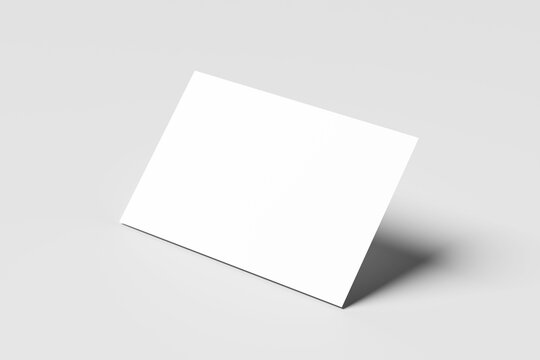 Blank mockup business card isolated on a minimalist grey background. 3x2 inc