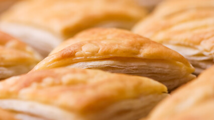 Golden brown baked puff pastry appetizers arranged together, showing flaky layers and a crispy texture
