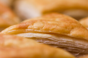 Golden flaky pastry crust close up showcasing delicious texture, perfect for bakery, snack, and food concepts