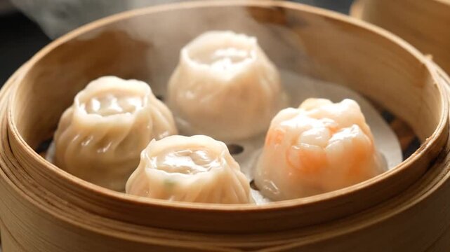 Steaming Hot Dim Sum Delights - A Close-Up of Traditional Chinese Dumplings in a Bamboo Steamer.