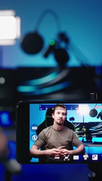 Tech person recording video with smartphone