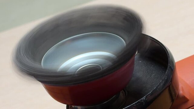 An angle grinder with a wire cup brush spins up slowly as the power toggles. The hesitant rotation generates a deep, pulsing mechanical thrum. This low-frequency vibration signals motor resistance.