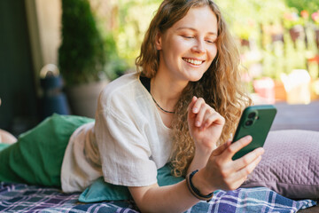 Happy Woman Using Smartphone on Summer Terrace