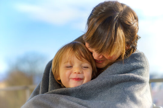 Portrait of happy little boy close to his mother