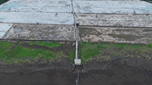 Aerial drone footage of salt pans on amed beach in bali, indonesia