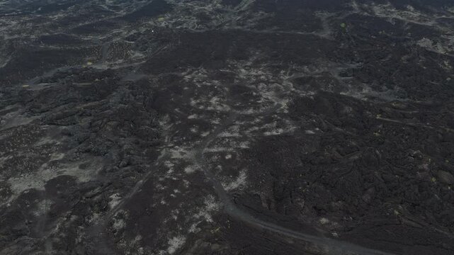 Aerial view flying over mount batur lava fields in bali