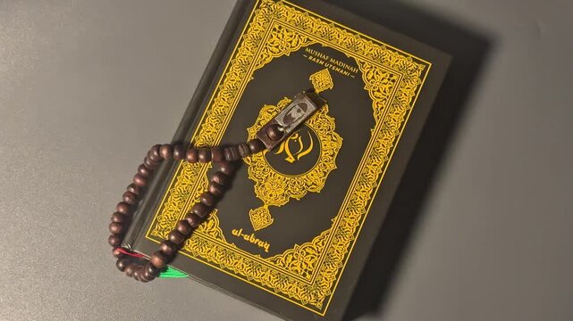 Sacred Text and Prayer Beads: A close-up shot of a meticulously crafted holy book adorned with intricate golden detailing, complemented by a string of prayer beads.
