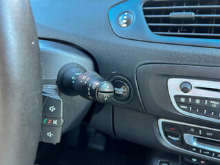 Fototapeta premium Car control panel shows the gear shift and start button in the interior of a vehicle during the daytime in a parking area