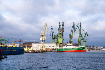 Fototapeta premium Panorama of Karstensen Shipyard in Gdansk with iconic green cranes.