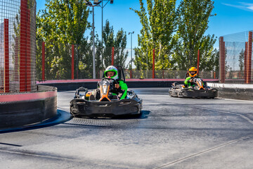 Kids racing go karts on track competition © unai
