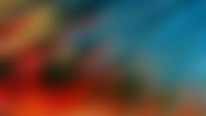 Abstract blurred gradient background with vibrant red, green, and blue spots.