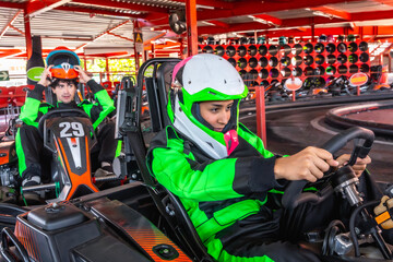Young men enjoying a karting race on indoor track © unai