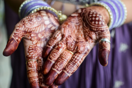 Beautiful woman dressed up as Indian tradition with henna mehndi design on her both hands to celebrate big festival of Karwa Chauth, Karwa Chauth celebrations by Indian woman for her husband