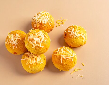 Stack of freshly baked nastar pineapple tart cookies with cheese topping on a plain background