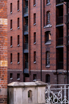 Heritage architecture on brick warehouse corner facade in Speicherstadt Hamburg Germany with industrial details captured in daylight shadows