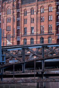 Heritage brick warehouse architecture with facade beside canal and bridge in Speicherstadt Hamburg Germany under bright daylight textures