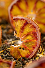 tea with added flavors and pieces of fruit and cut red oranges, bright large dry slices of blood...