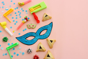 Purim celebration concept (jewish carnival holiday) over pink background