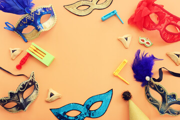 Purim celebration concept (jewish carnival holiday) over yellow background