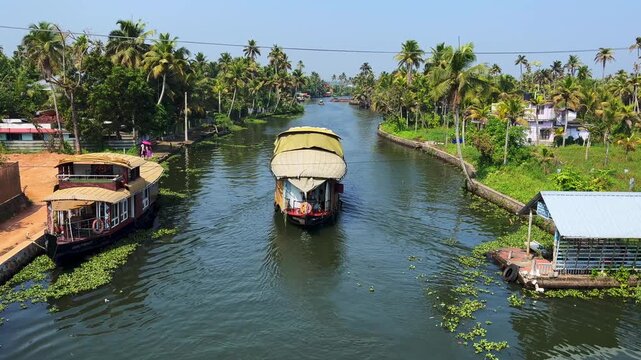 Traditional houseboats cruising through the backwaters of Kerala, India