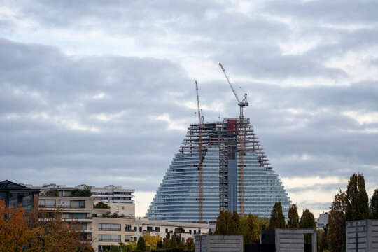 Modern construction scene in Paris France with crane and building development transforming the skyline under cloudy skies showing active architecture growth