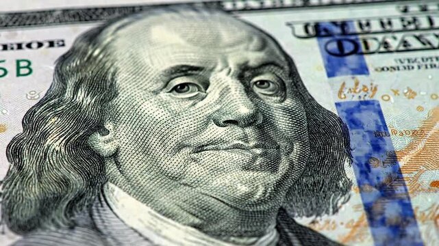 The Power of Finance: Extreme close-up of Benjamin Franklin's face on a hundred dollar bill, perfect for concepts of wealth, investment, and economic growth.