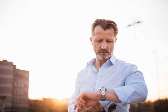 Portrait of mature man checking the time