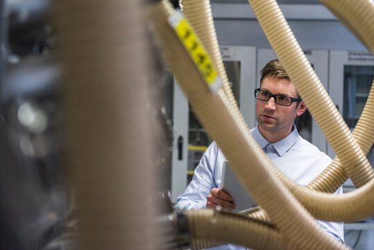 Man examining the system in factory