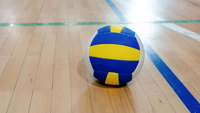 Volleyball on a wooden court floor