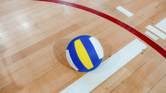 Volleyball ball on an indoor wooden court floor