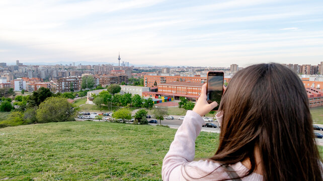 Woman capturing city view at Tio Pio Park in Madrid