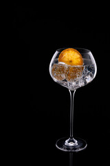 Refreshing gin tonic cocktail with dried orange slice