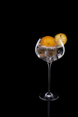 Gin tonic cocktail with orange and lemon garnish