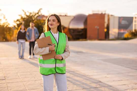 Female student in safety vest conducting field research