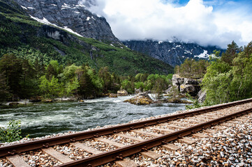 Railway tracks running over a mountain river in Norway © KoshMara