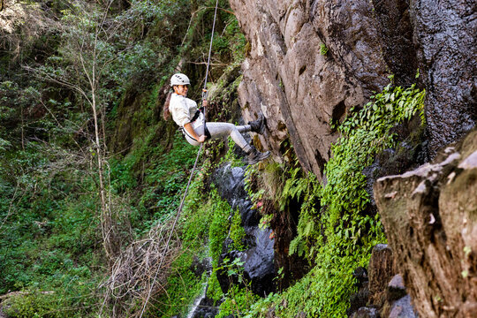 Thrilling rappel down a verdant cliffside